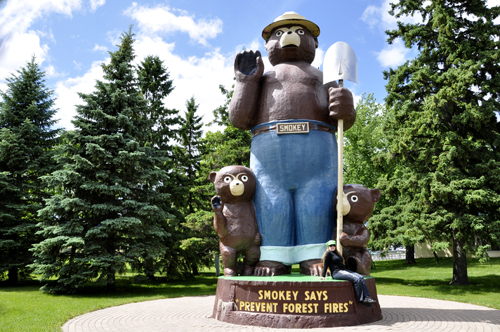 Karen Duquette and the Smokey Bear carving